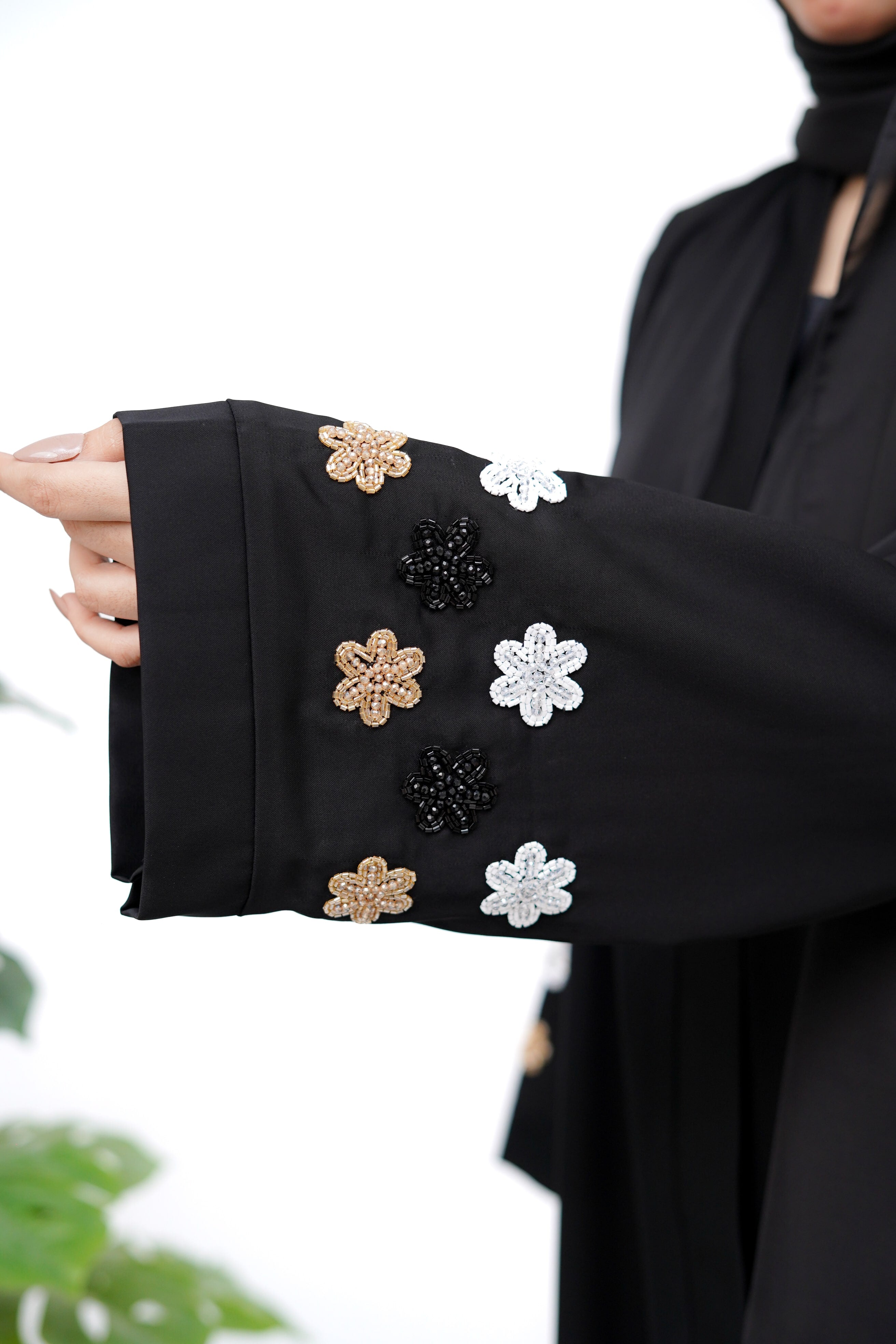 Clarity Glam best black abaya sleeve with gold black and white floral embellishments in close-up