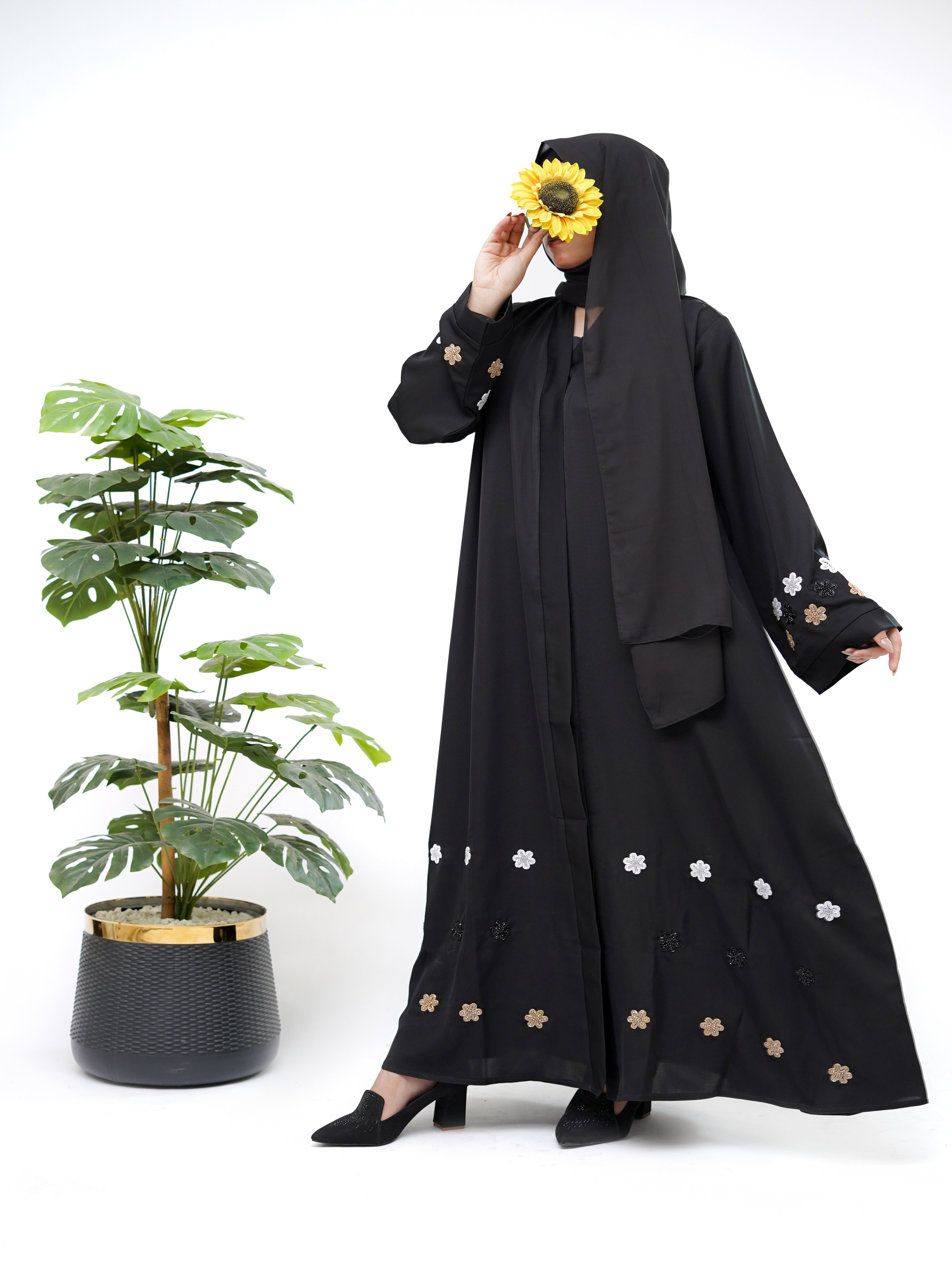 Clarity Glam best black abaya with floral embroidery on sleeves and hem worn with black heels