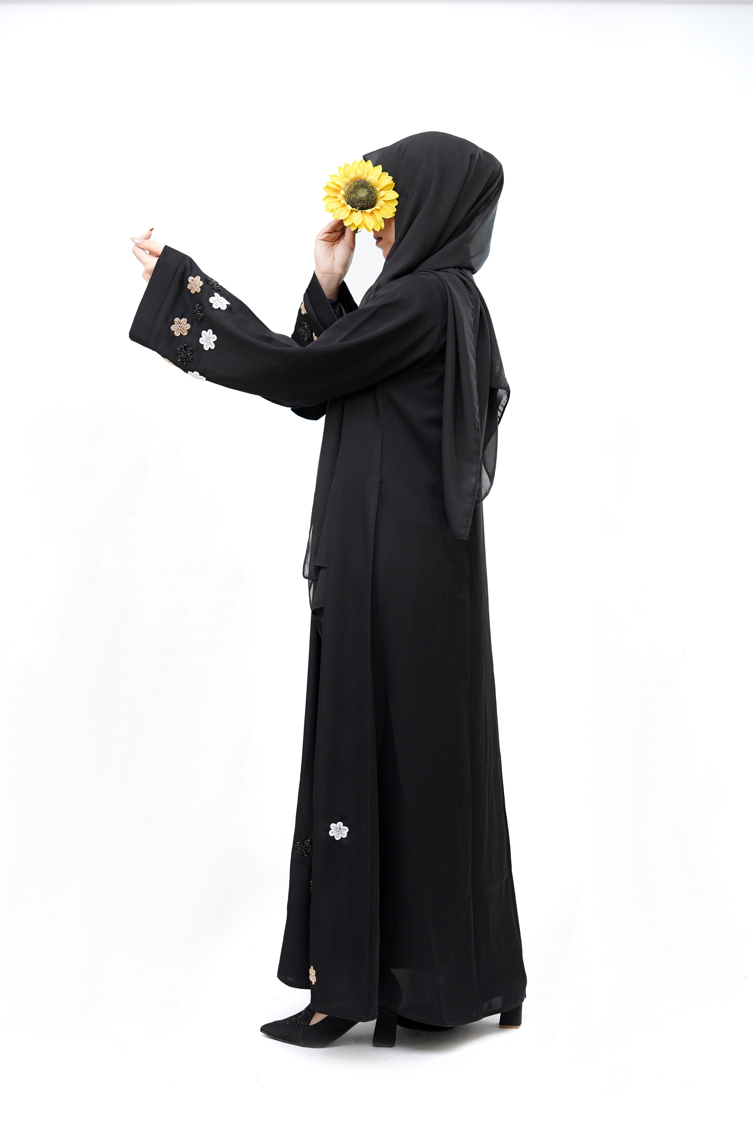 Clarity Glam best black abaya with floral embroidery on sleeves and hem worn with matching black heels