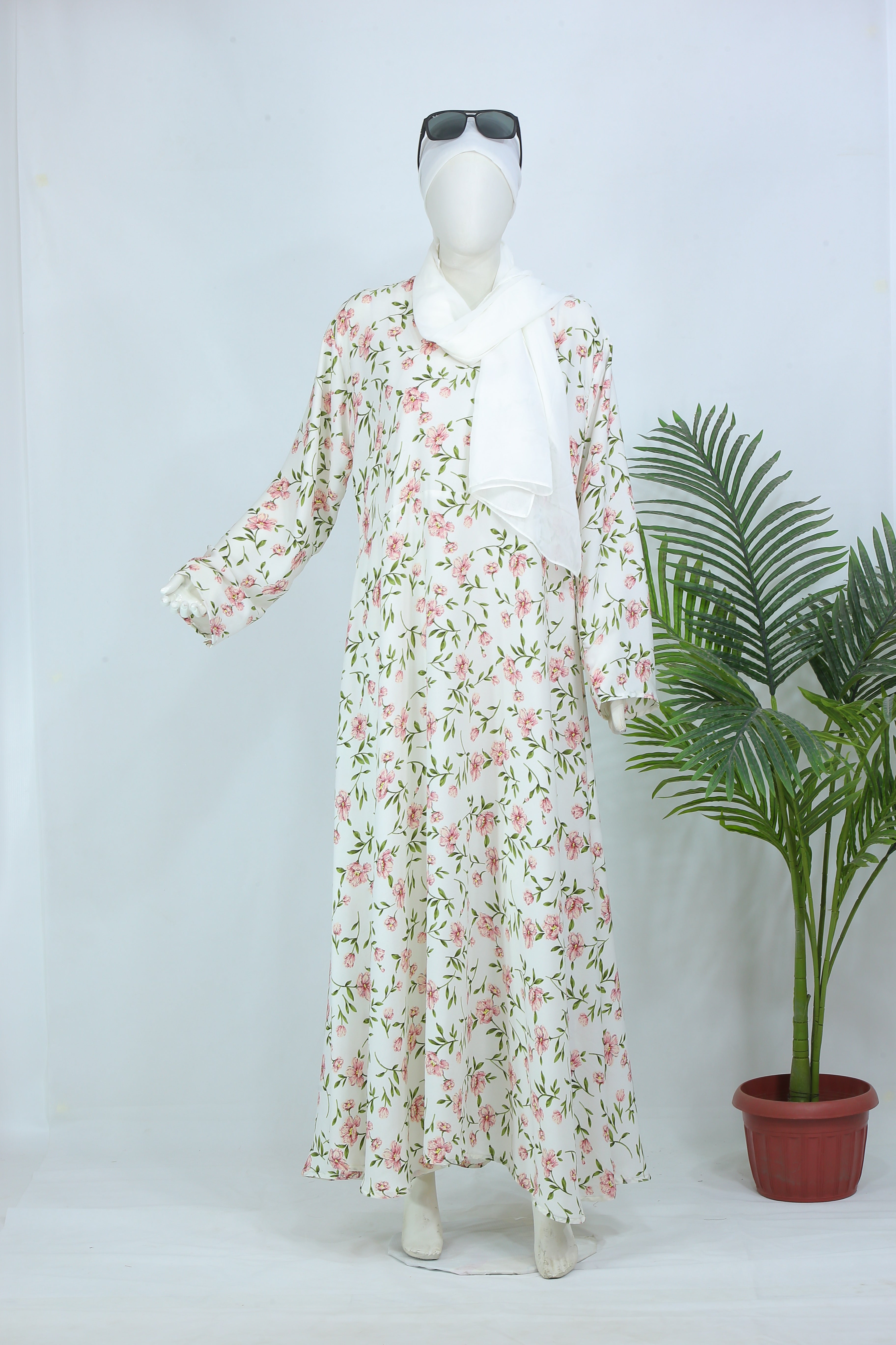 Clarity Glam floral abaya with scarf in white featuring pink and green floral patterns on mannequin