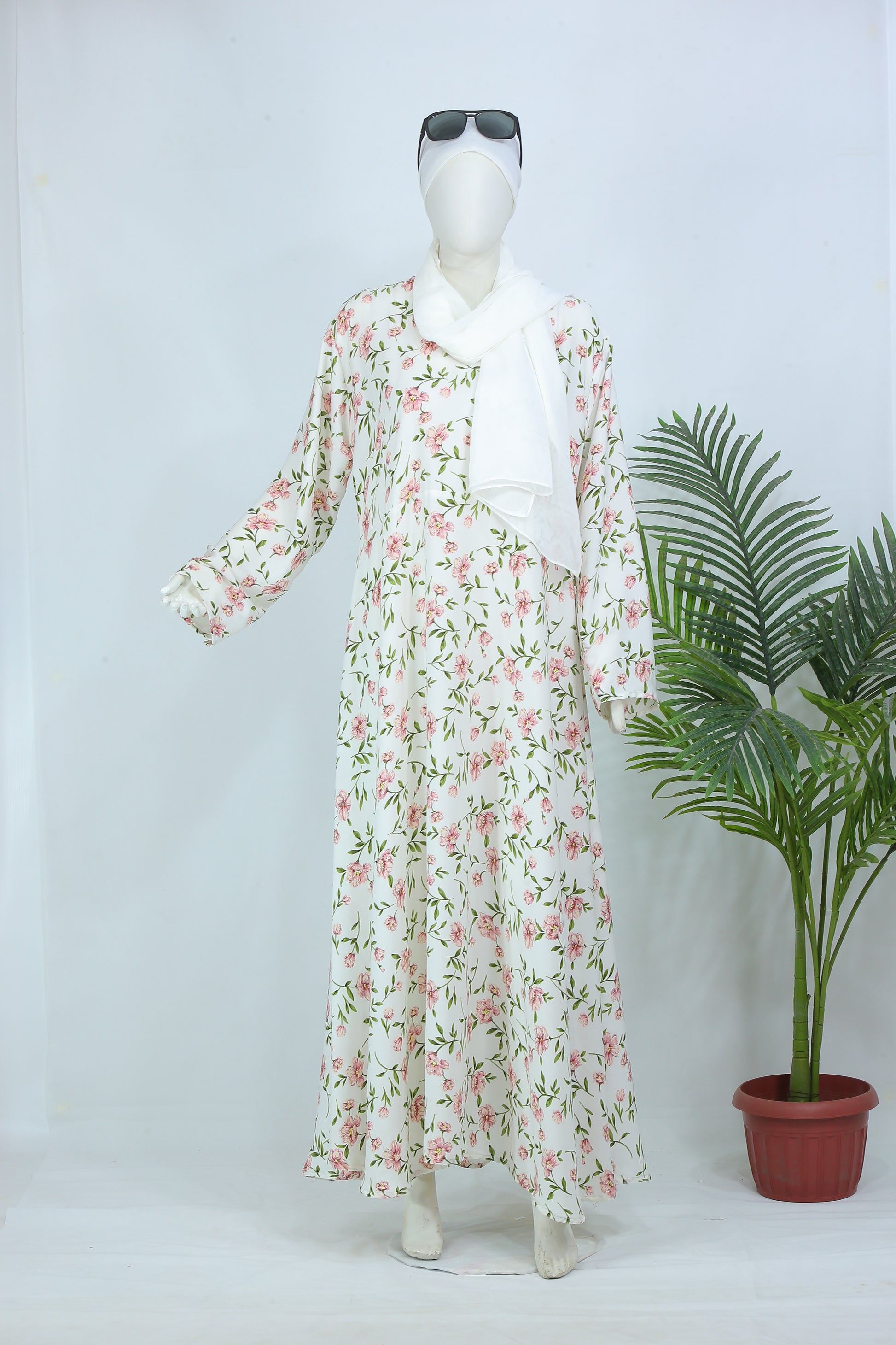 Clarity Glam floral abaya with scarf in white featuring pink and green floral patterns on mannequin