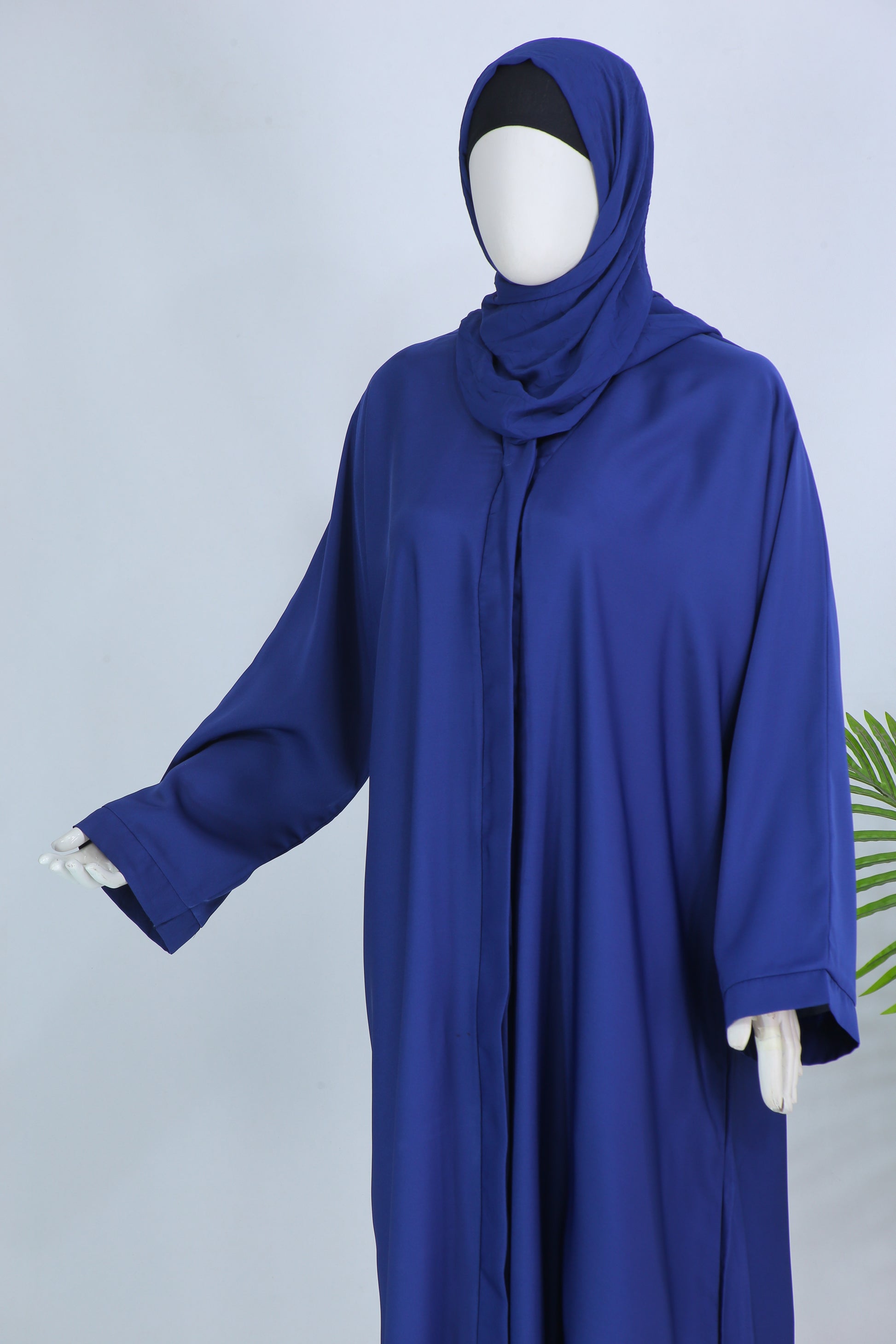 Clarity Glam modern blue abaya for women with long sleeves and matching hijab on mannequin