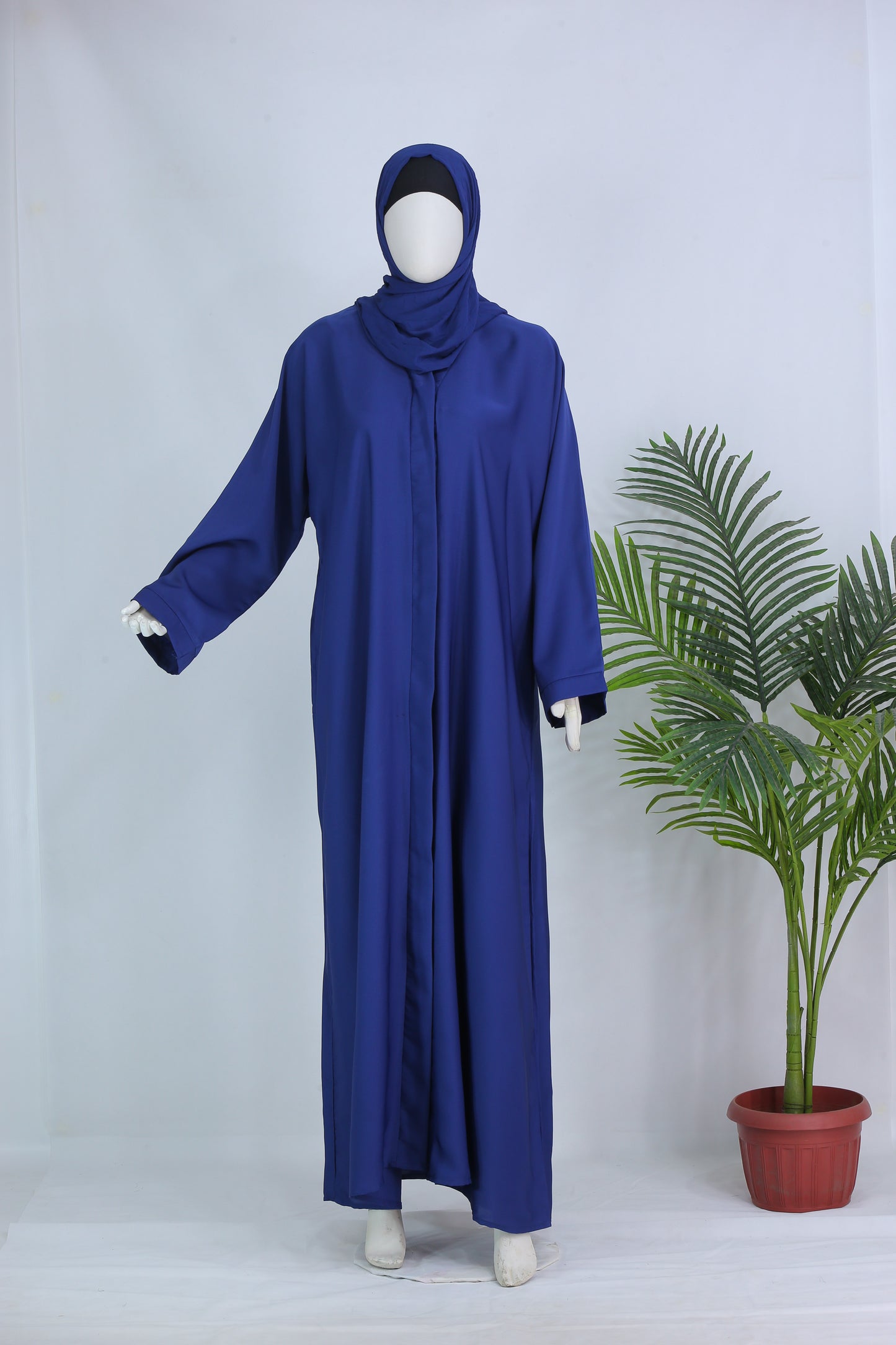 Modern blue abaya for women displayed on mannequin with full sleeves and matching hijab