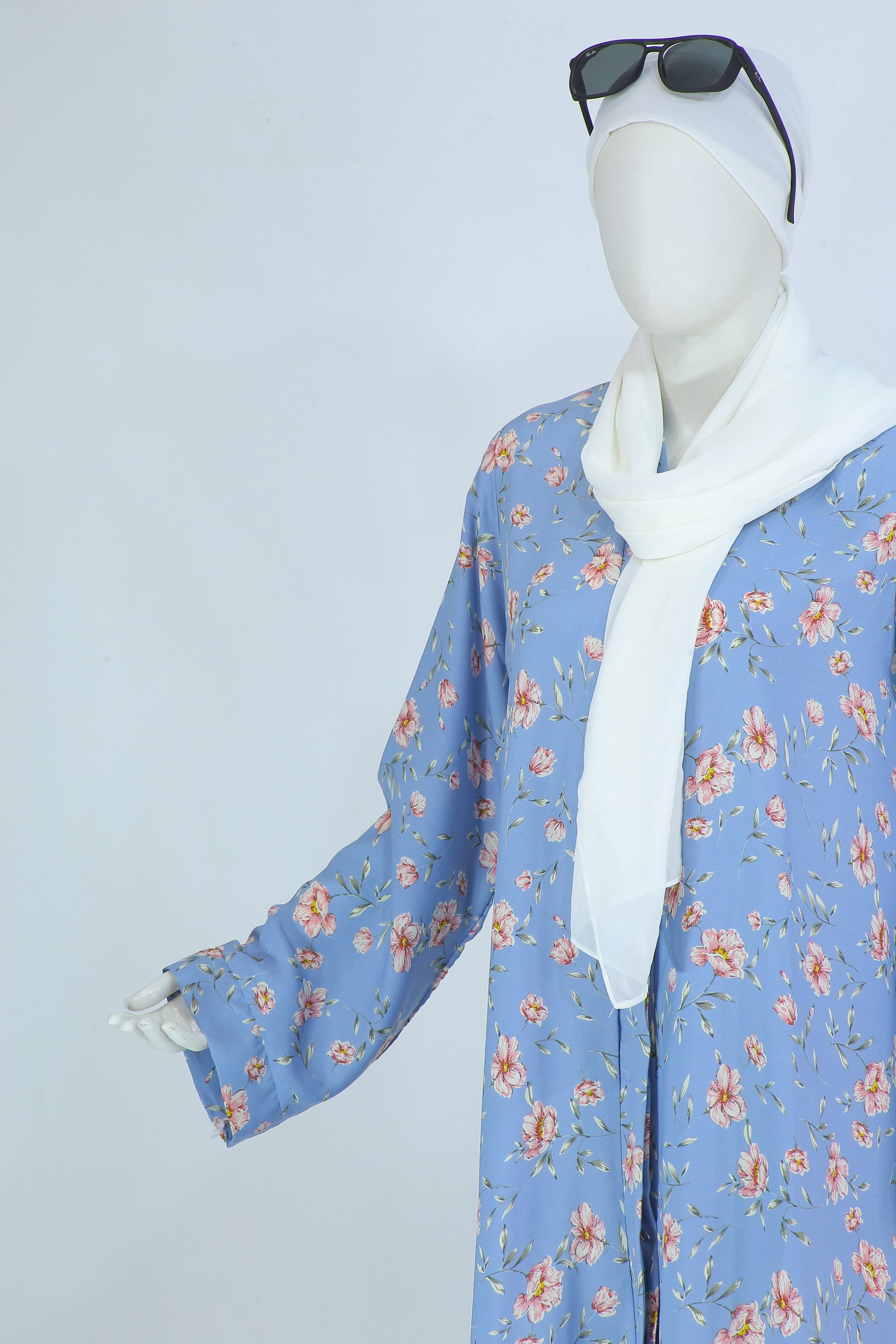 Clarity Glam Sky Blush abaya Pakistan with floral print in blue and white hijab on mannequin