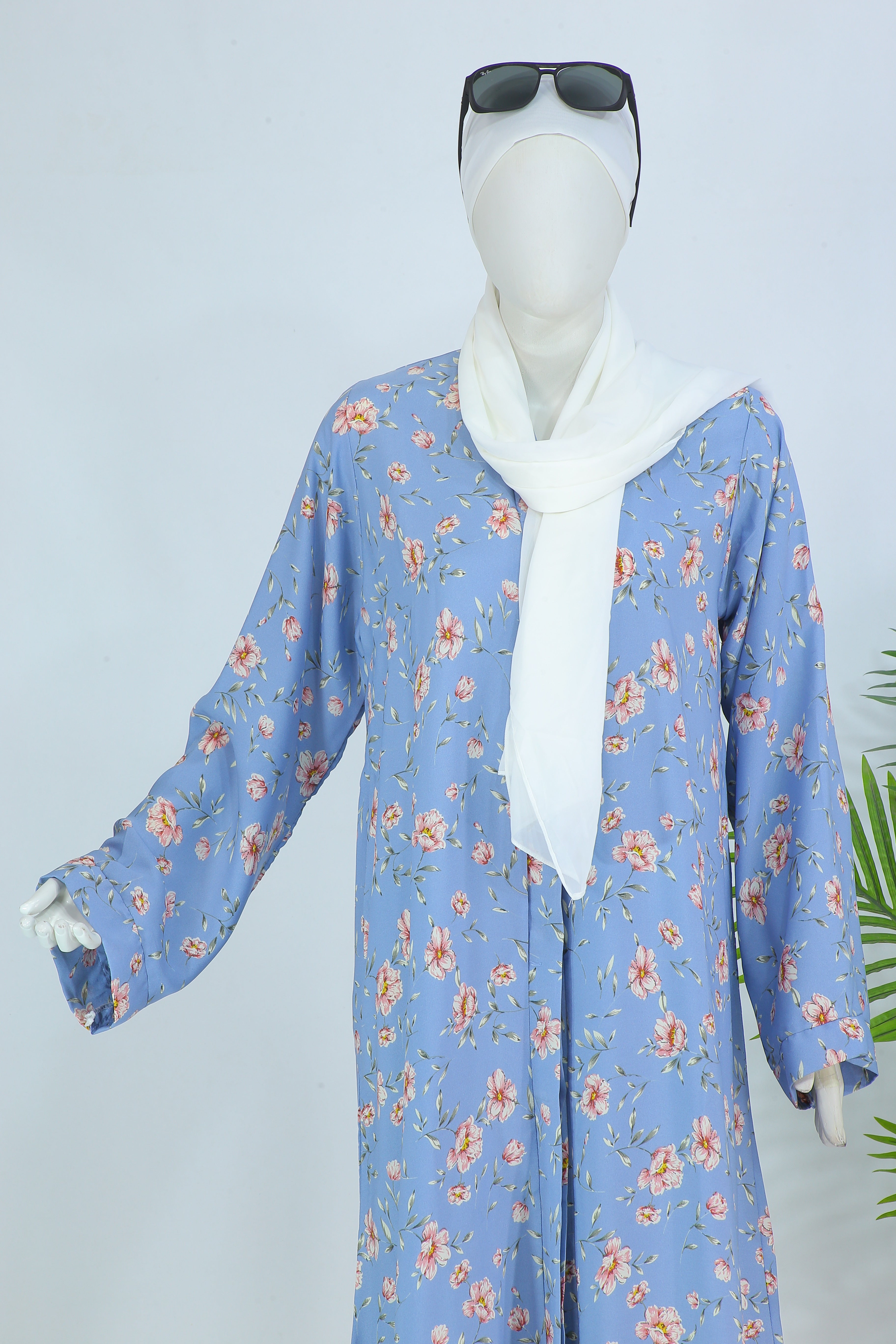 Clarity Glam Sky Blush abaya Pakistan in blue with floral print and white hijab styled on mannequin