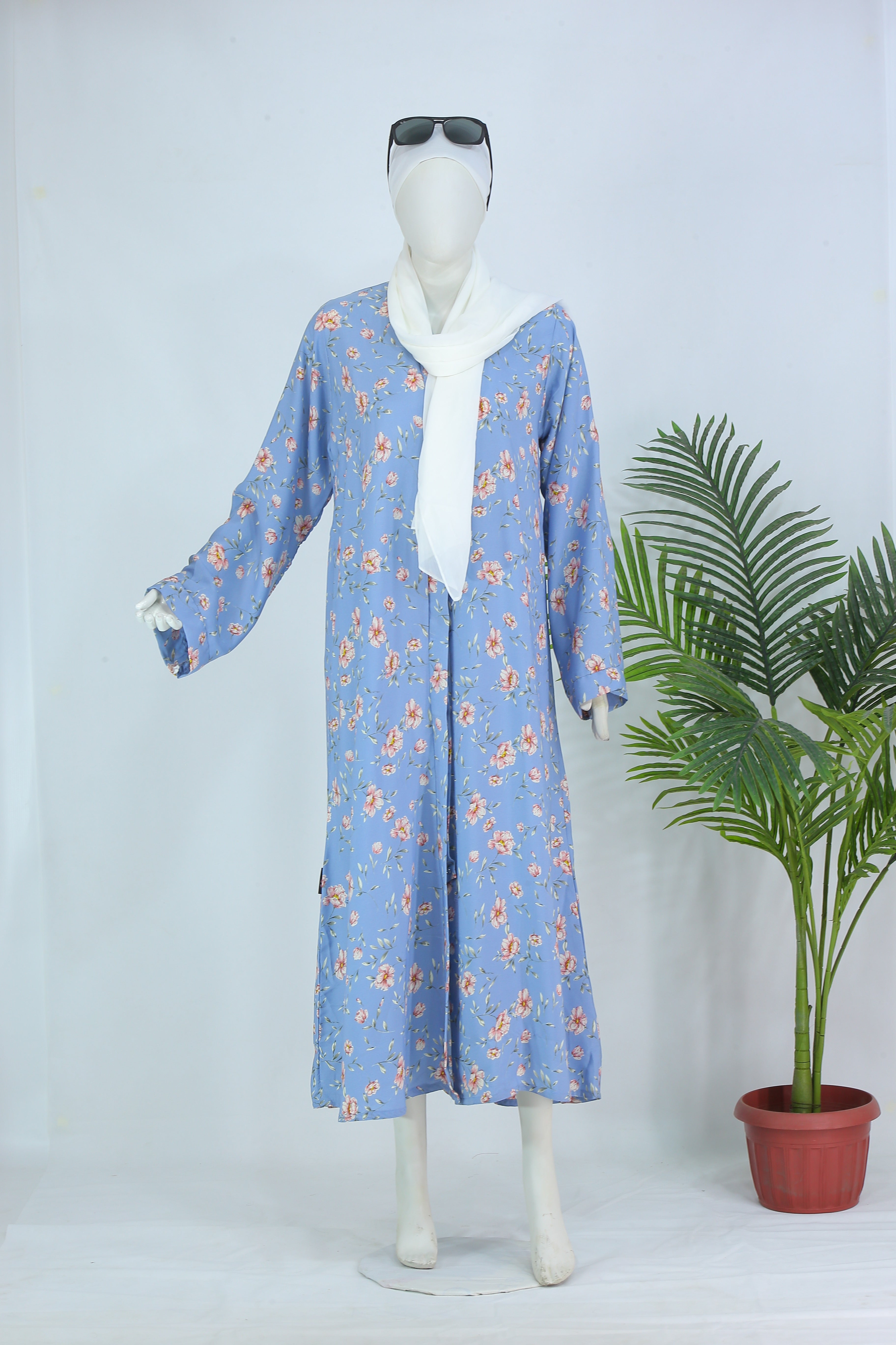 Sky Blush abaya Pakistan by Clarity Glam in blue floral pattern with white scarf on mannequin
