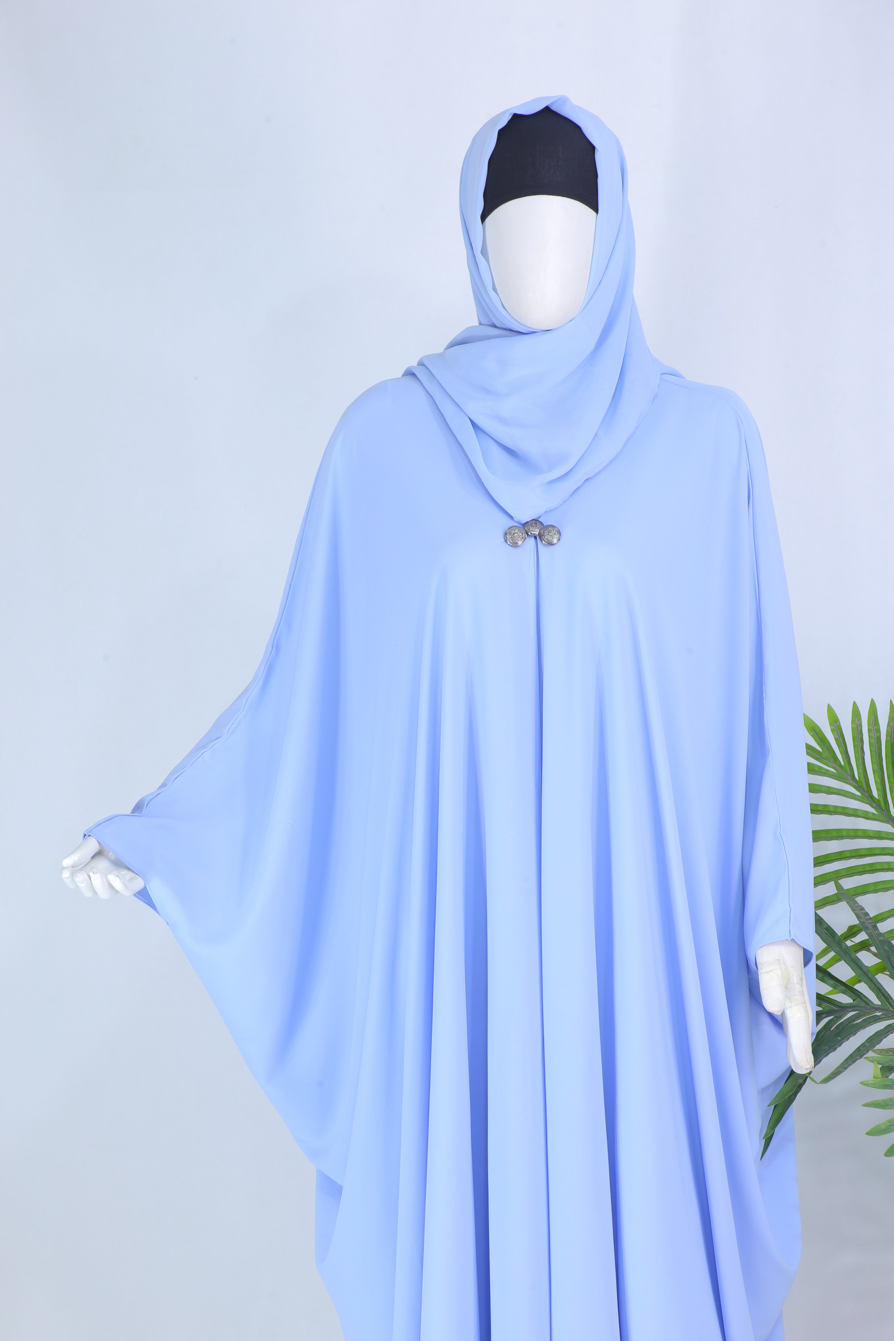 Clarity Glam Sky Blue abaya with flowing fabric and simple embellishment on mannequin
