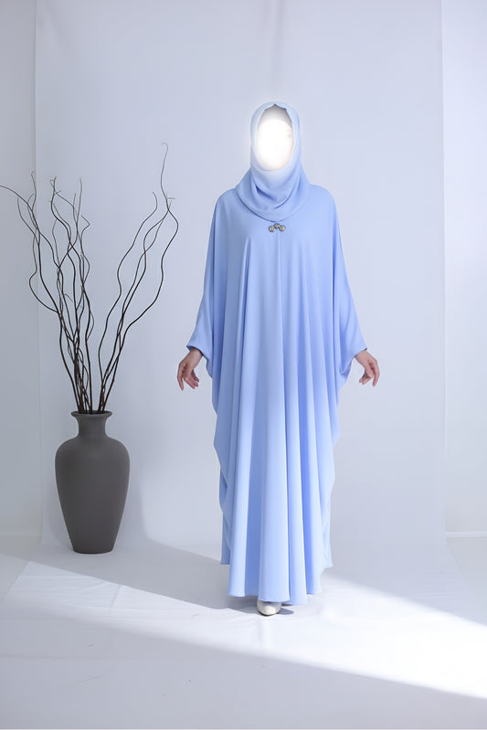 Clarity Glam sky blue abaya with flowing fabric and modest design on a mannequin in white studio