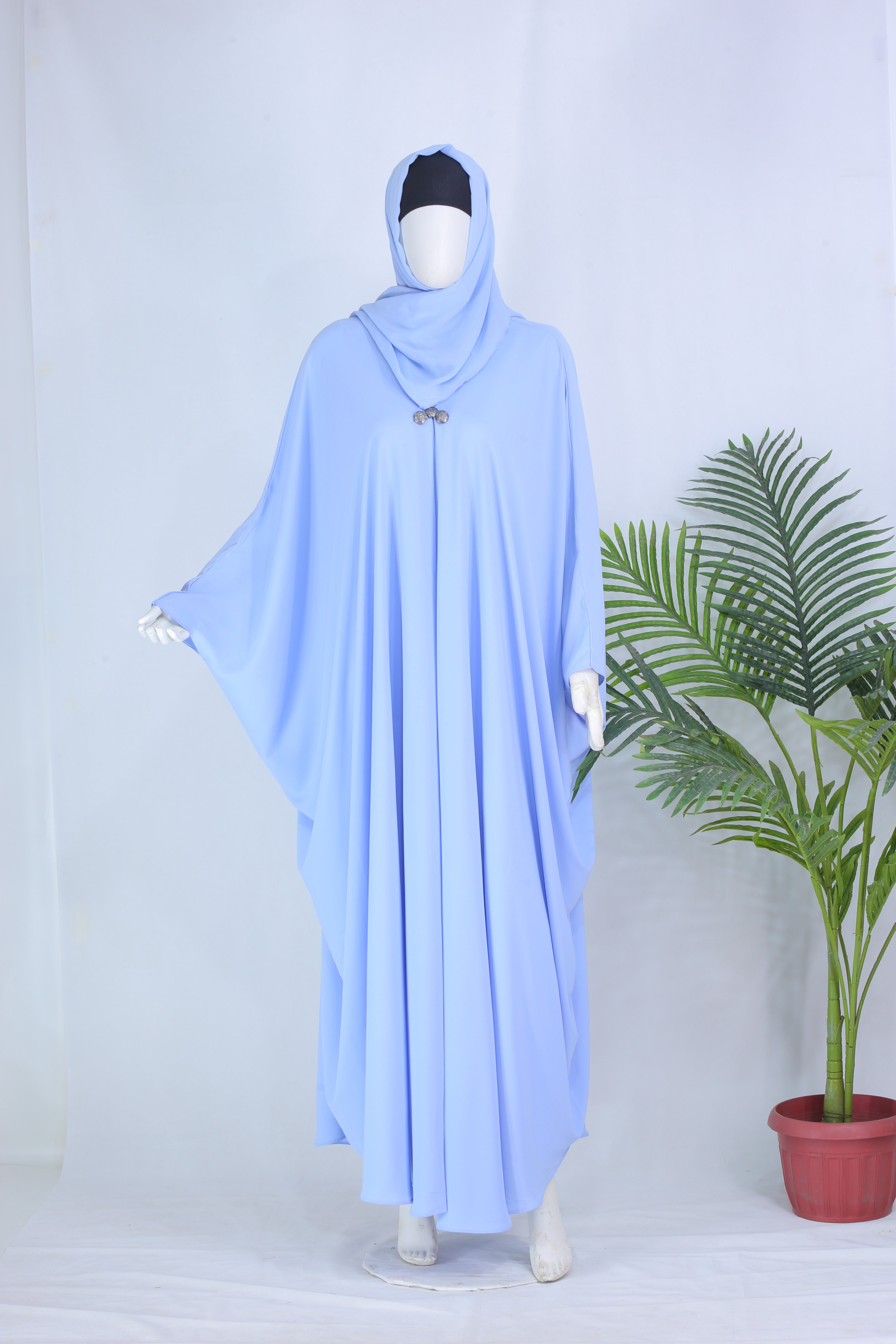 Sky Blue abaya by Clarity Glam displayed on mannequin with flowing fabric and matching headscarf