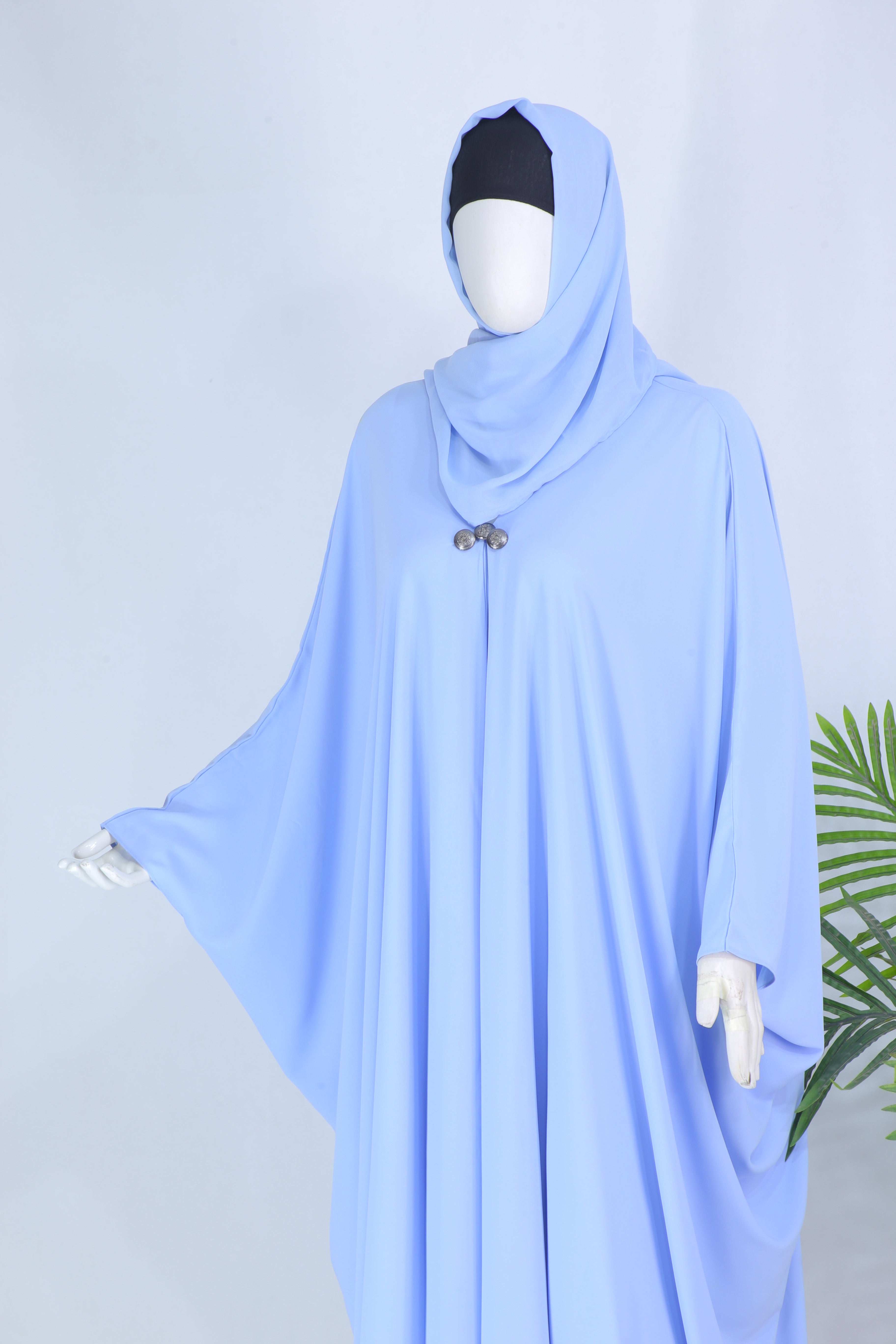 Clarity Glam Sky Blue abaya displayed on mannequin with flowing fabric and modest design